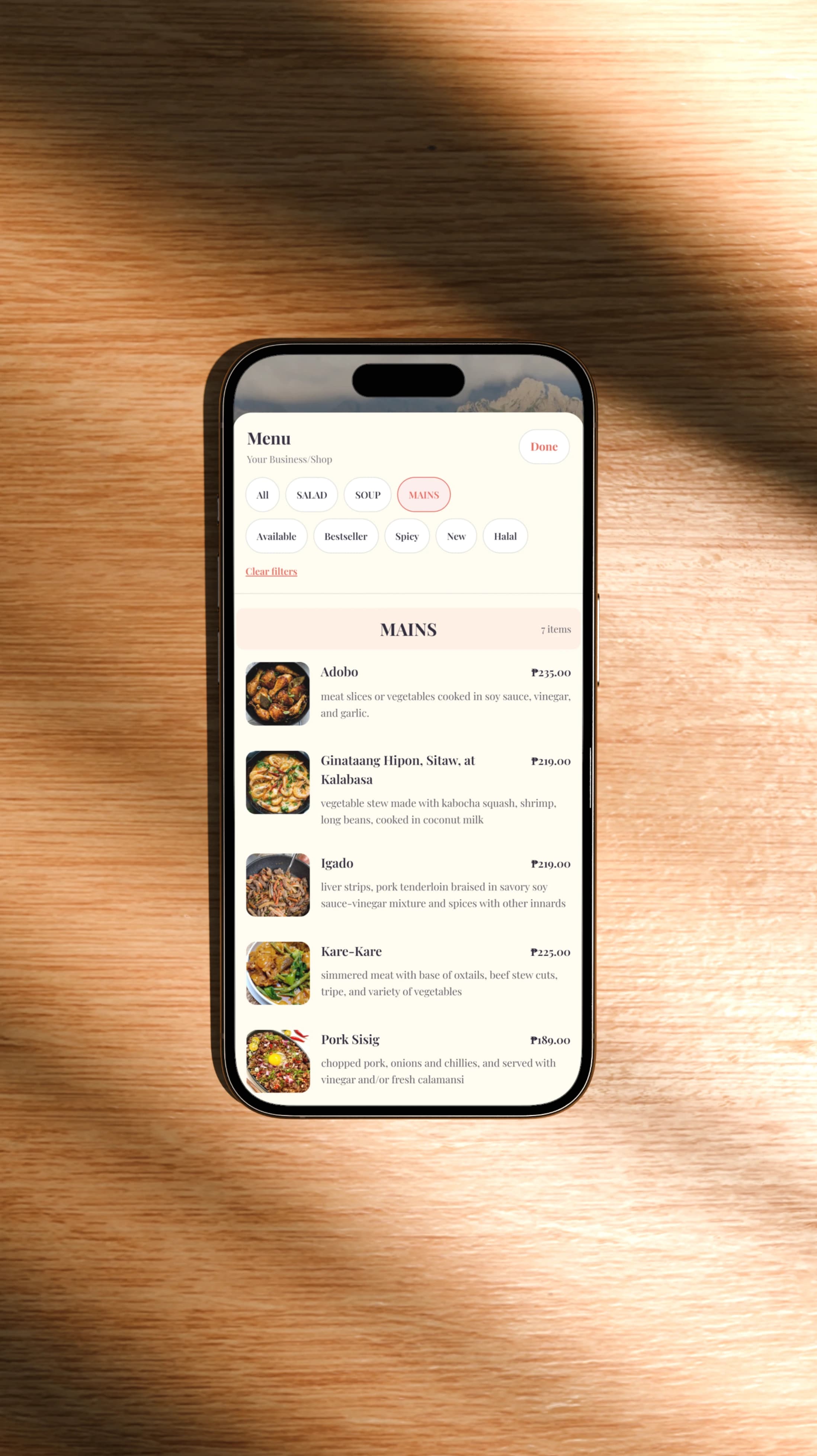 A phone displaying a white BumpLnk digital menu on a wooden surface
