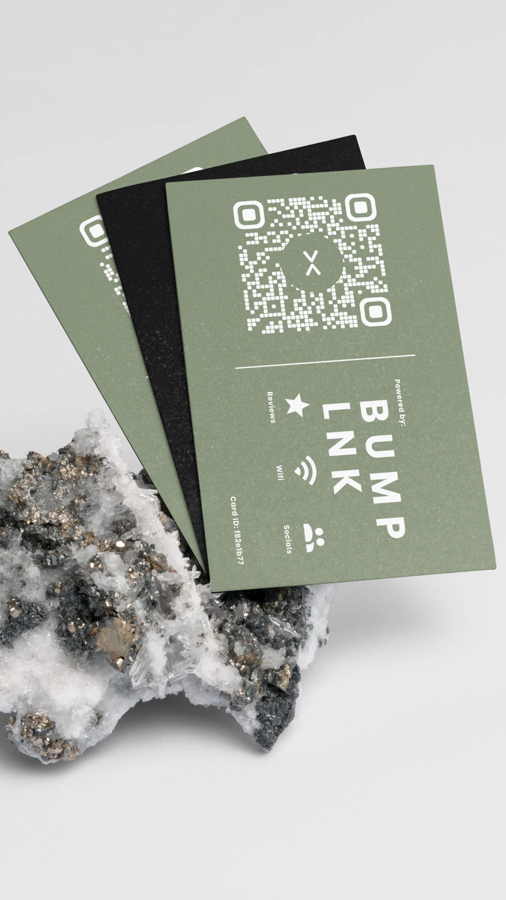Stacked green and black BumpLnk cards beside a crystal